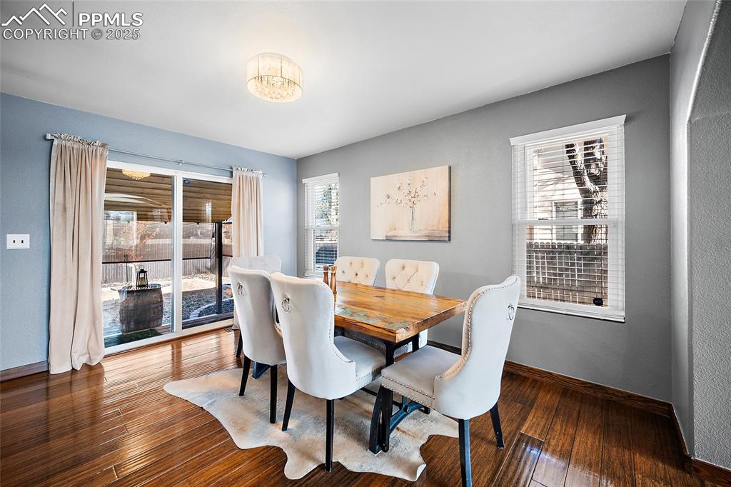 7015 Reunion Circle Fountain, CO 80817 - Photo 6 of 41 a dining room with furniture and wooden floor