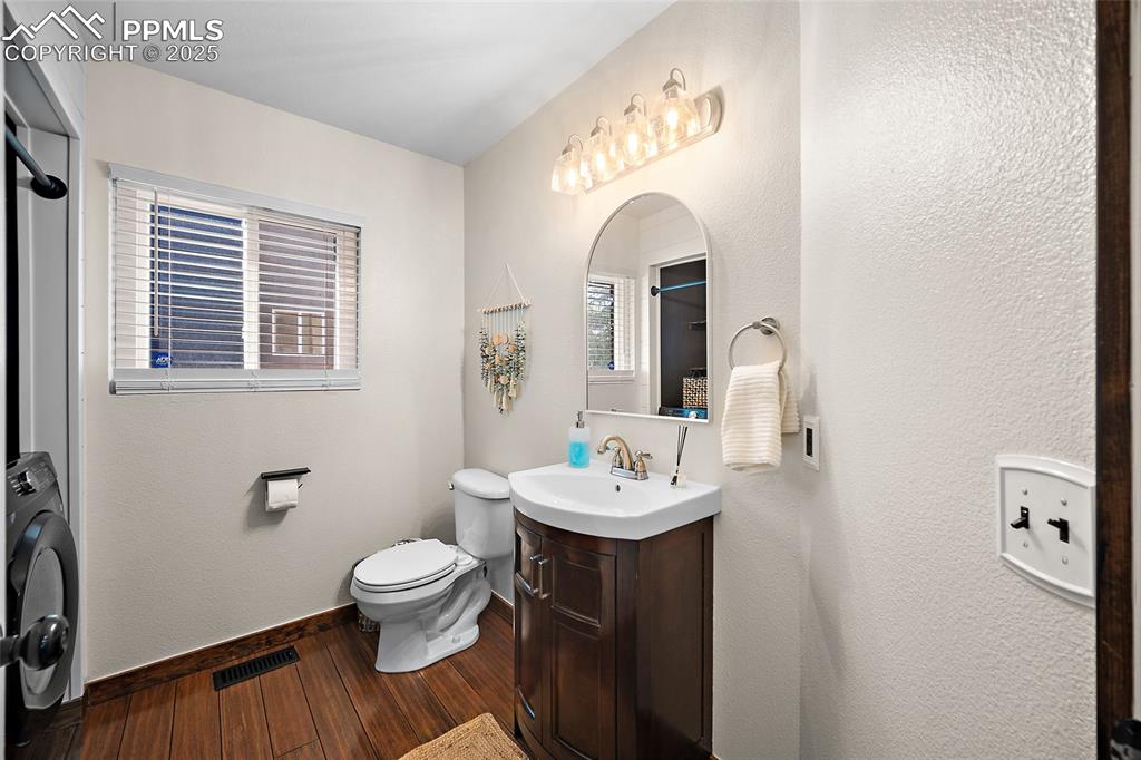 7015 Reunion Circle Fountain, CO 80817 - Photo 8 of 41 a bathroom with a toilet a sink and mirror