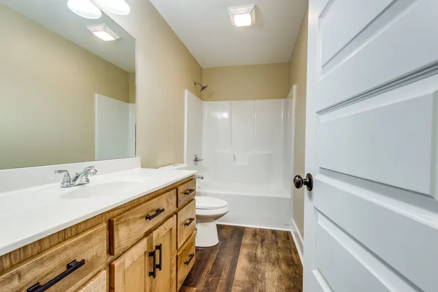 a view of a house with a big yard and large trees