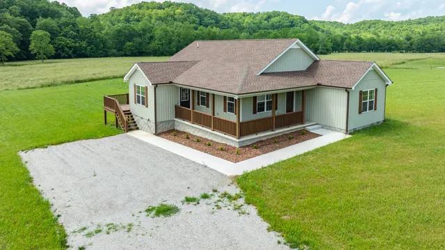 a view of a golf course with potted plants