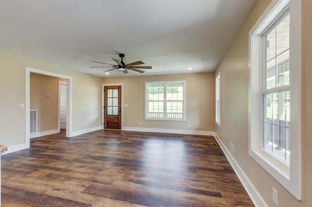 a large kitchen with stainless steel appliances granite countertop a lot of counter space and wooden floors