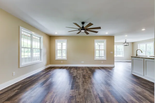 a kitchen with granite countertop a sink stove and refrigerator