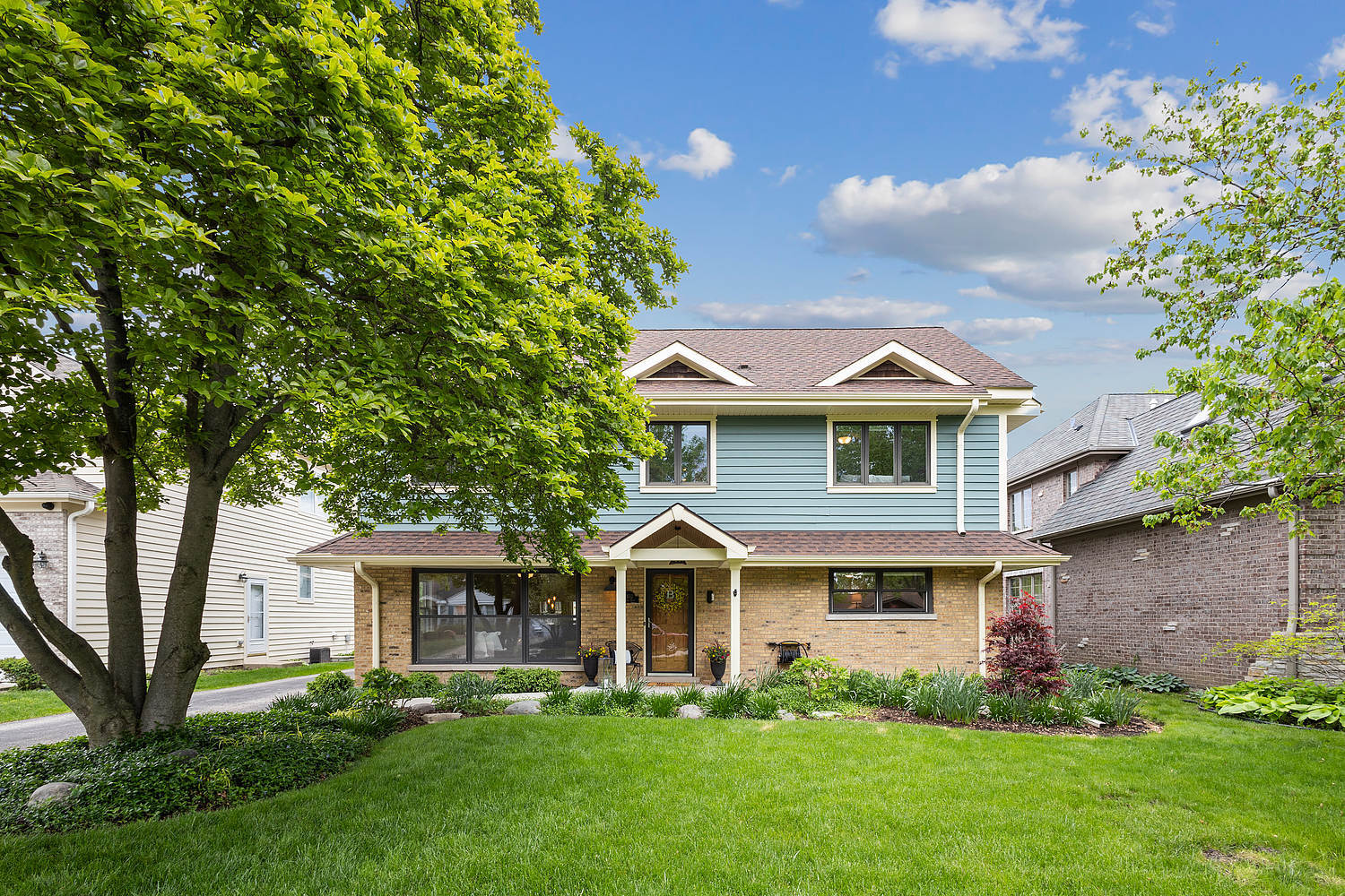 2432 Illinois Road Northbrook, IL 60062 - Photo 1 of 22 a front view of a house with a garden and trees