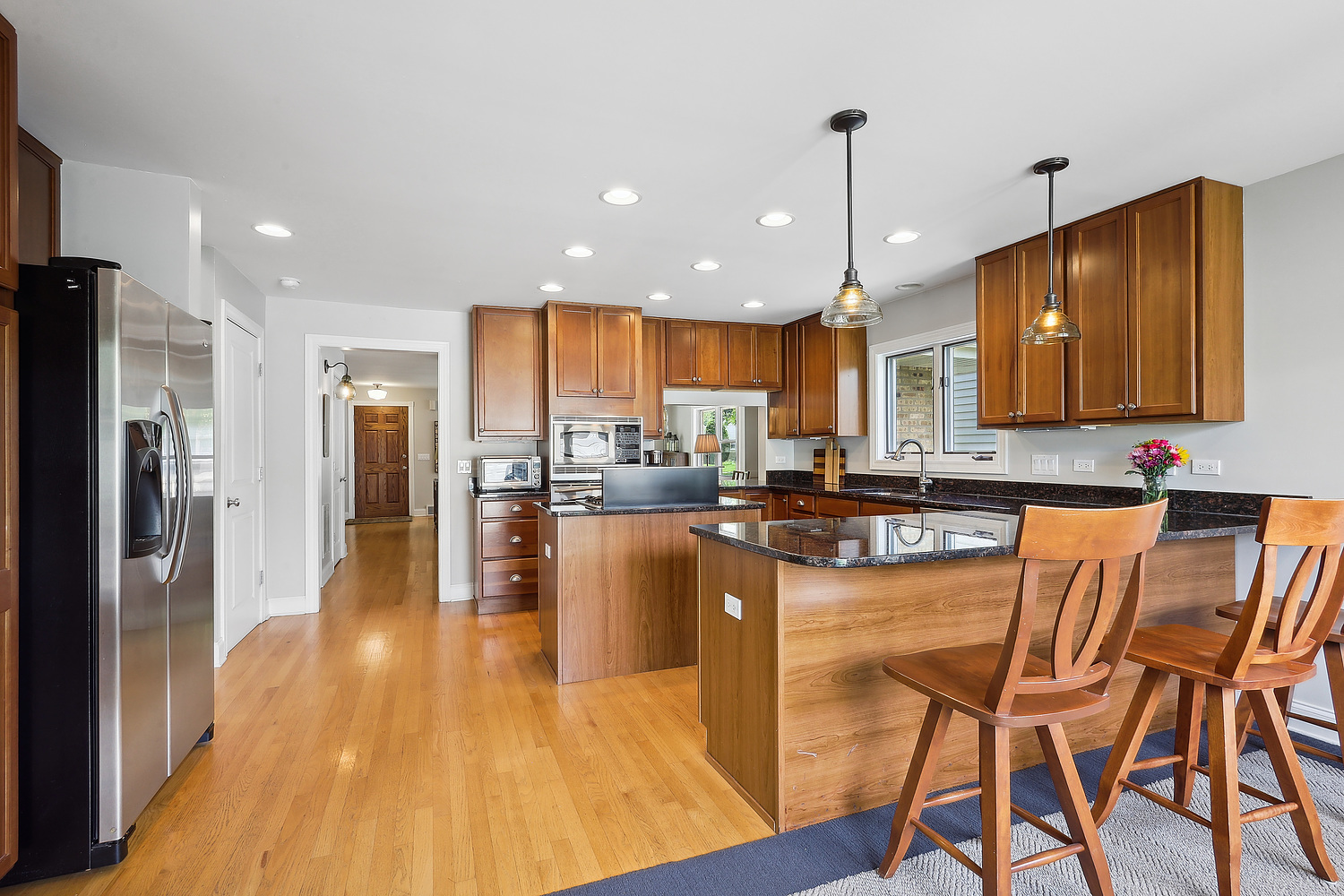 2432 Illinois Road Northbrook, IL 60062 - Photo 6 of 22 a kitchen with stainless steel appliances granite countertop a refrigerator a stove top oven and a center island