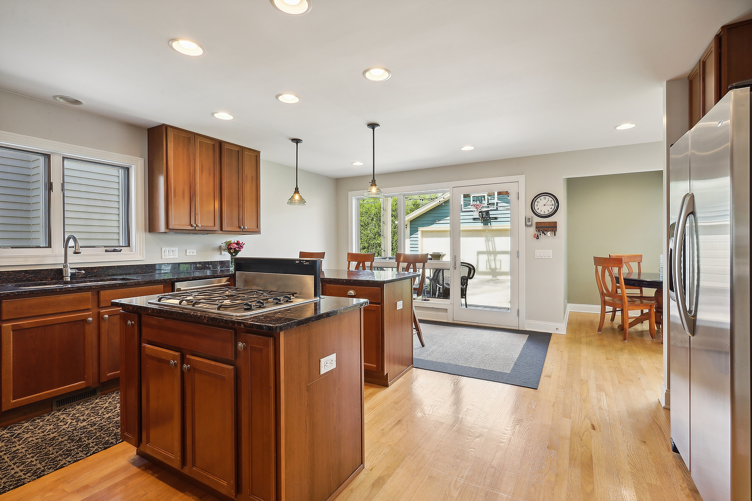 2432 Illinois Road Northbrook, IL 60062 - Photo 7 of 22 a kitchen with stainless steel appliances granite countertop a sink stove and wooden floor