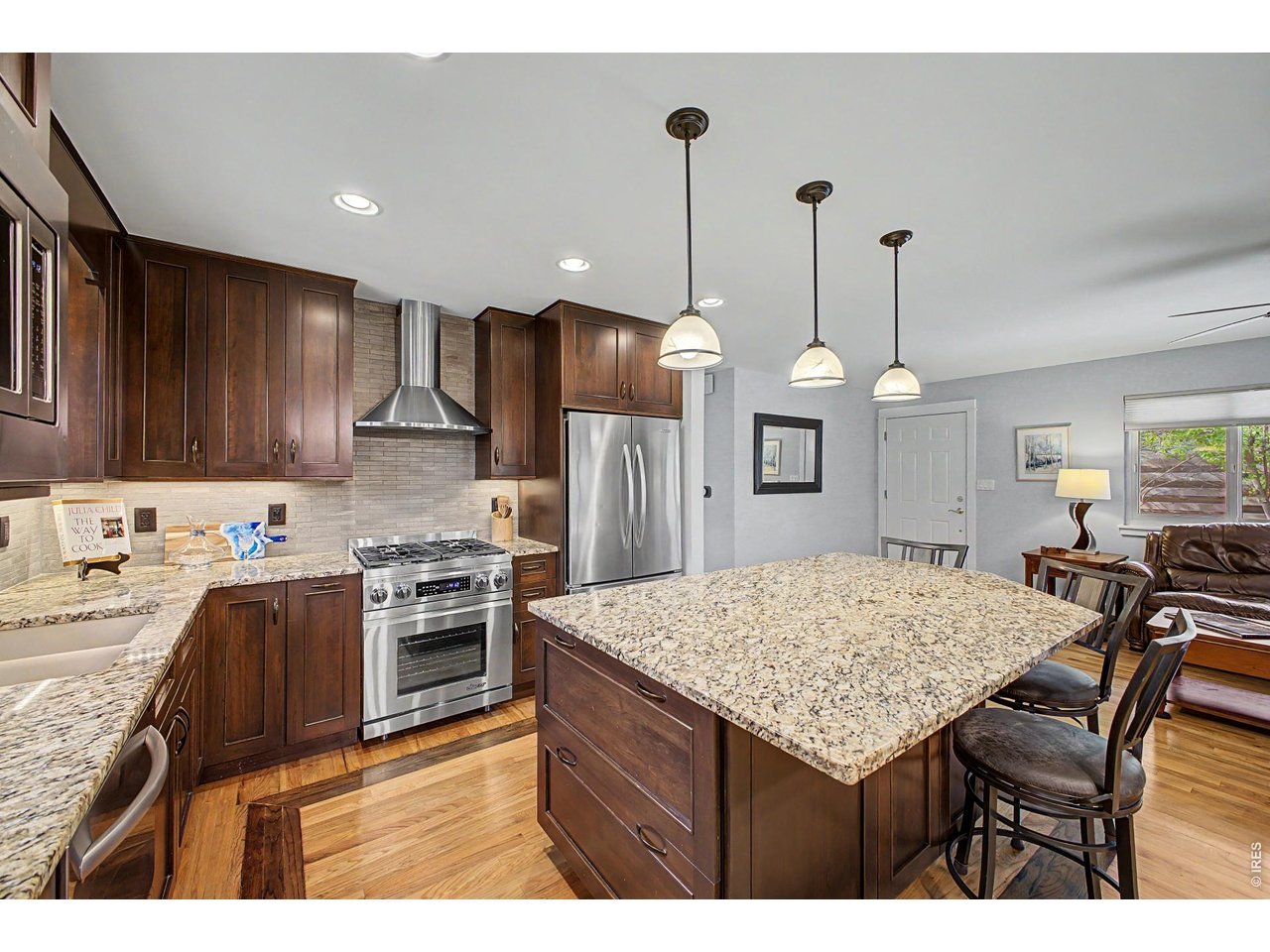 1453 Chestnut Place Boulder, CO 80304 - Photo 14 of 32 a kitchen with kitchen island granite countertop wooden cabinets and a stove