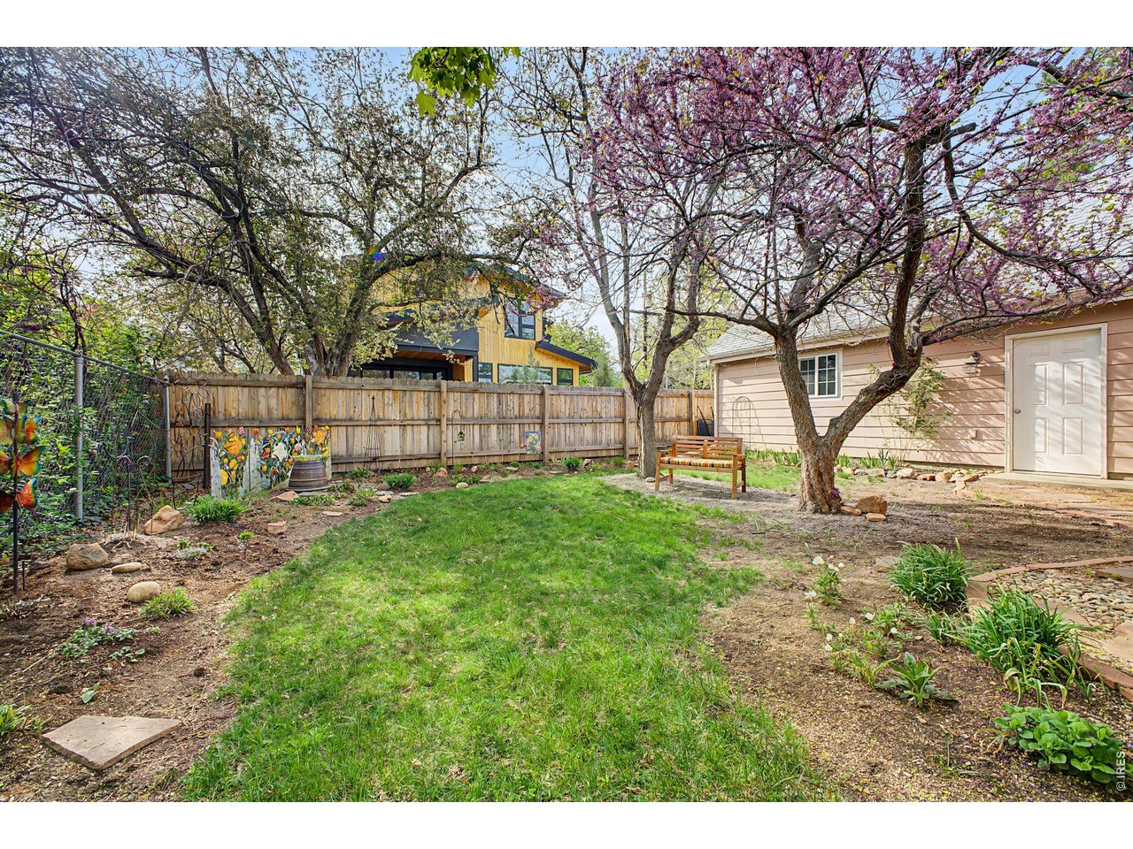 1453 Chestnut Place Boulder, CO 80304 - Photo 24 of 32 a view of a yard with large trees and a barn