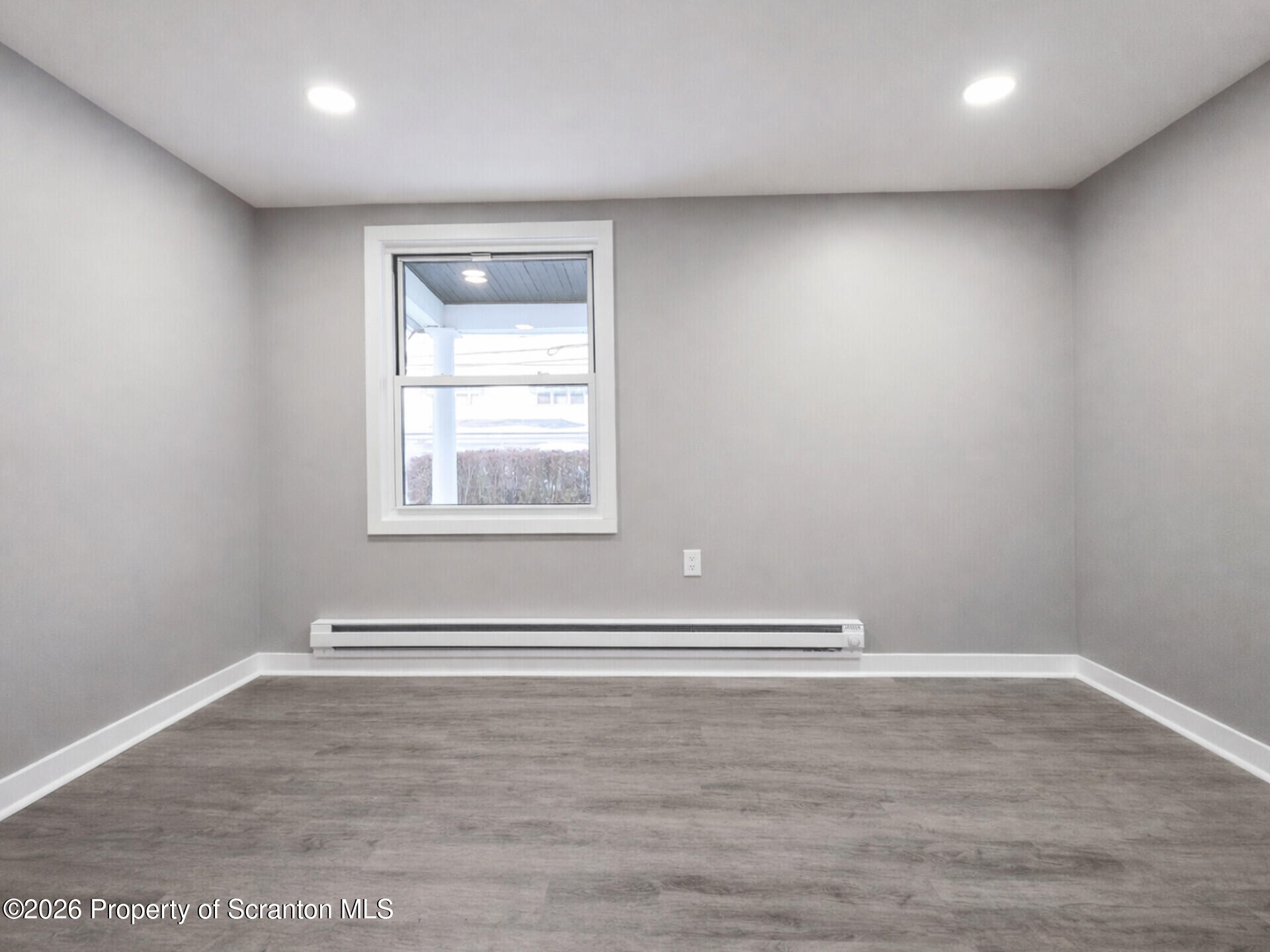 1215 Eynon Street Scranton, PA 18504 - Photo 11 of 23 a view of an empty room with wooden floor and a window