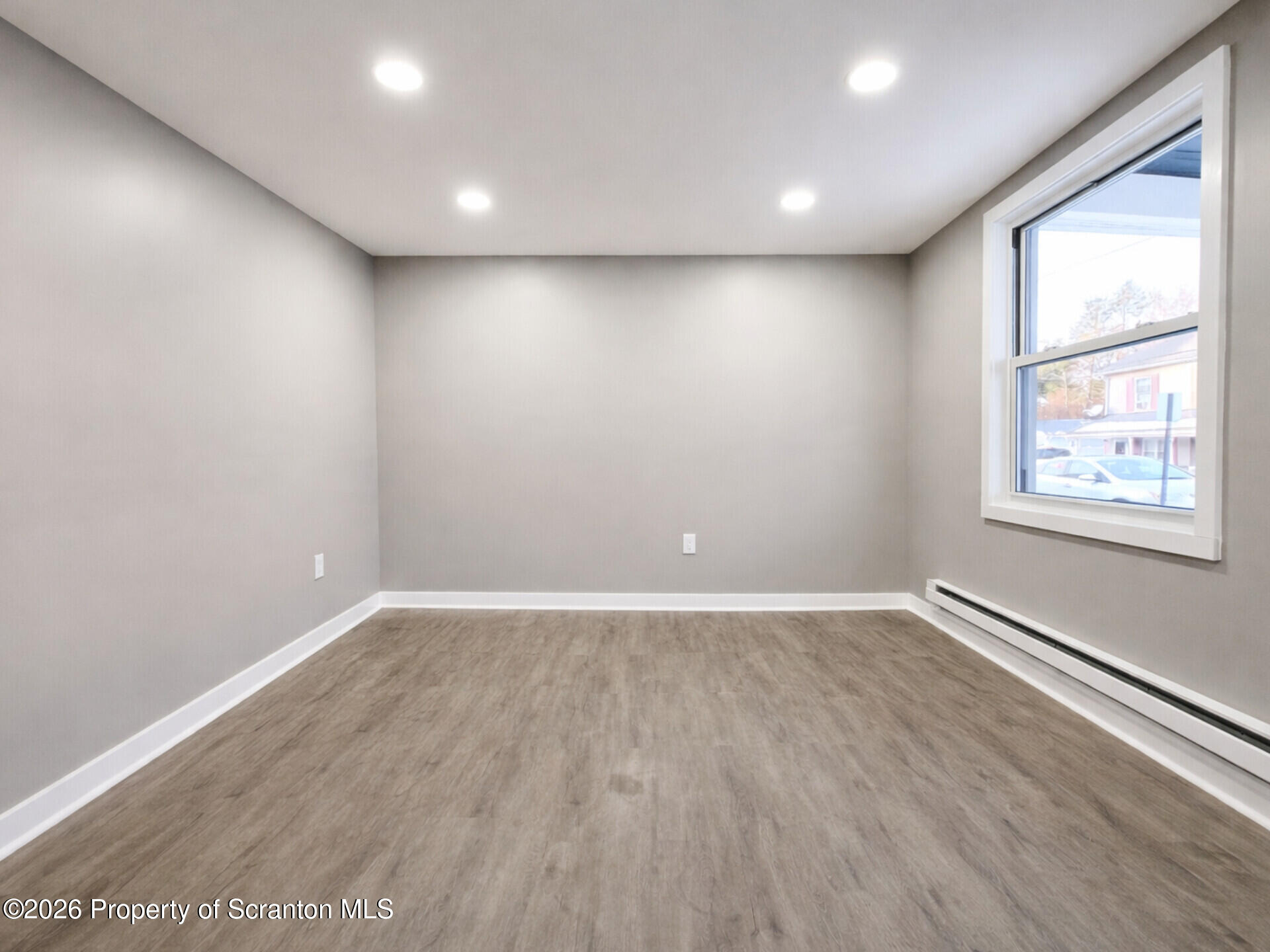 1215 Eynon Street Scranton, PA 18504 - Photo 12 of 23 an empty room with wooden floor and windows