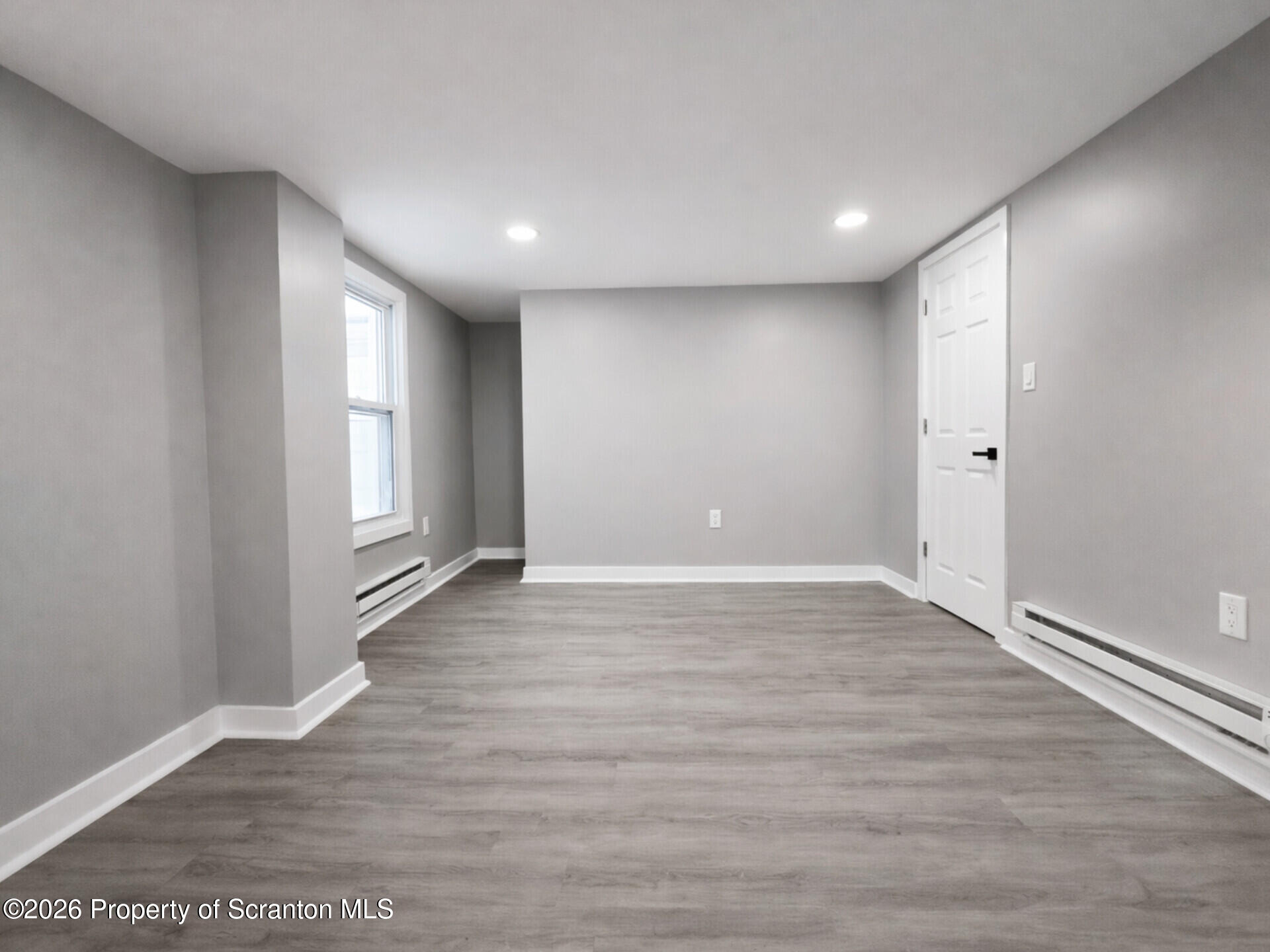 1215 Eynon Street Scranton, PA 18504 - Photo 14 of 23 a view of an empty room with wooden floor