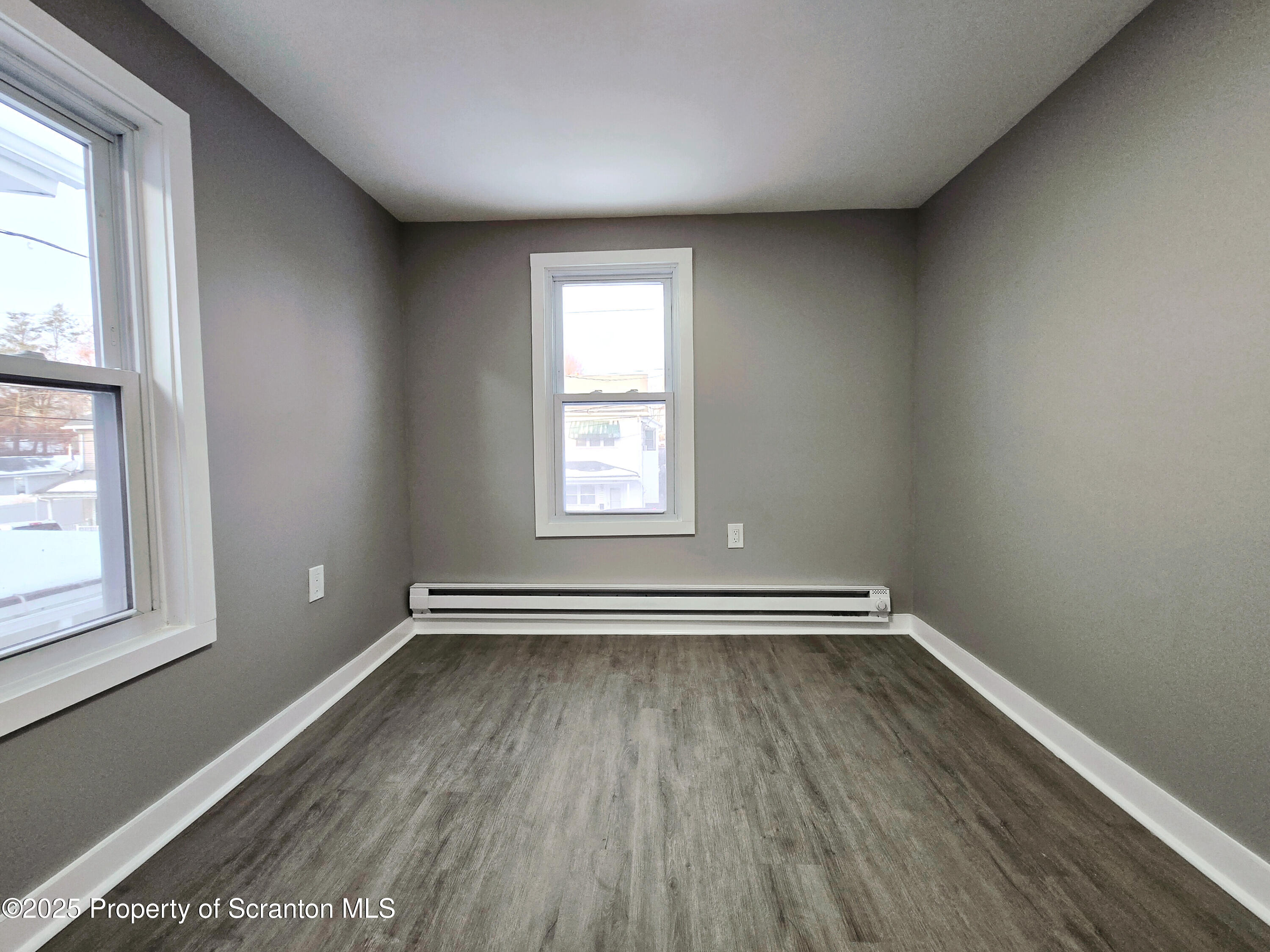 1215 Eynon Street Scranton, PA 18504 - Photo 16 of 23 an empty room with wooden floor and windows