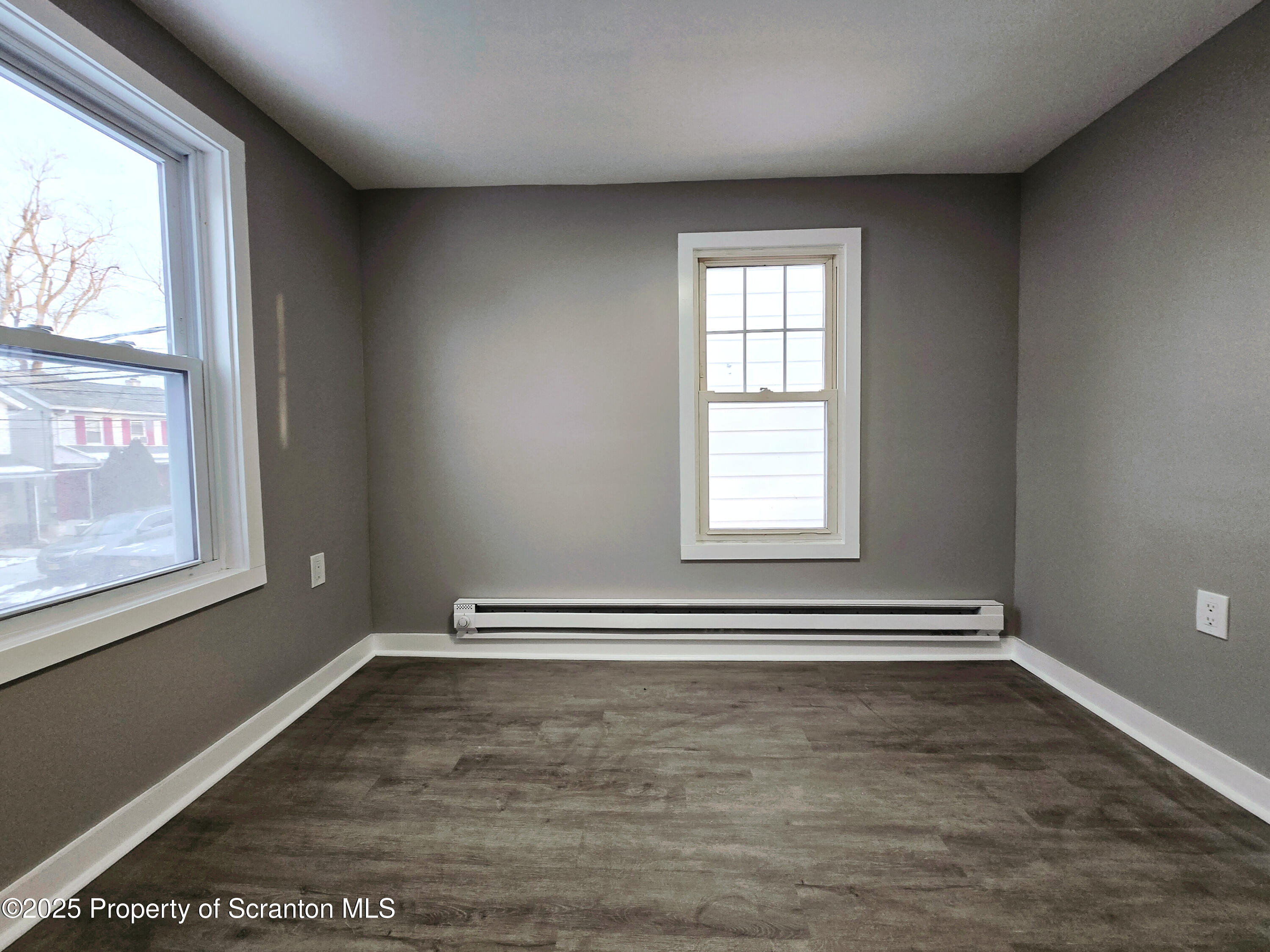 1215 Eynon Street Scranton, PA 18504 - Photo 18 of 23 an empty room with wooden floor and windows