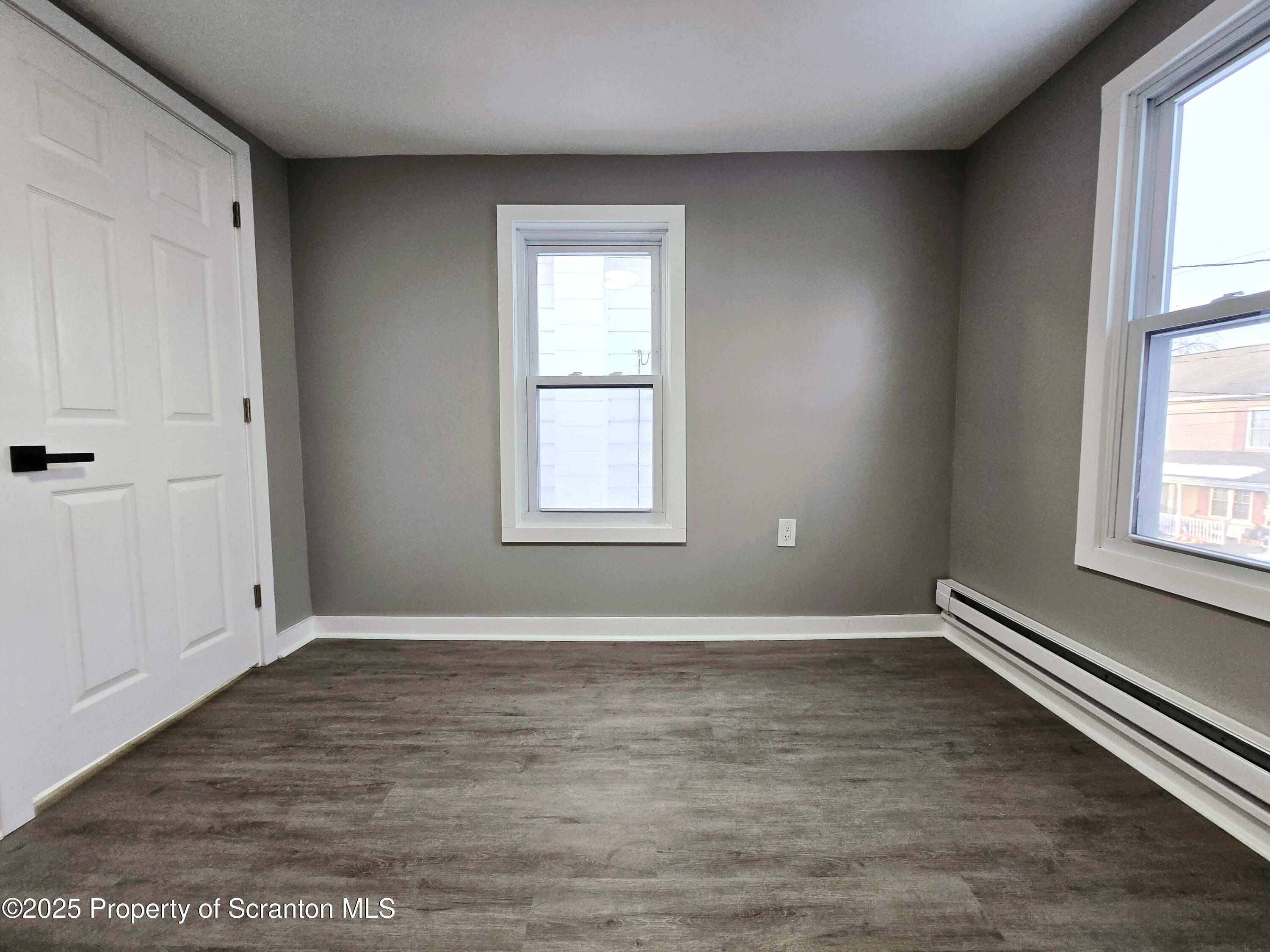 1215 Eynon Street Scranton, PA 18504 - Photo 21 of 32 an empty room with wooden floor and windows