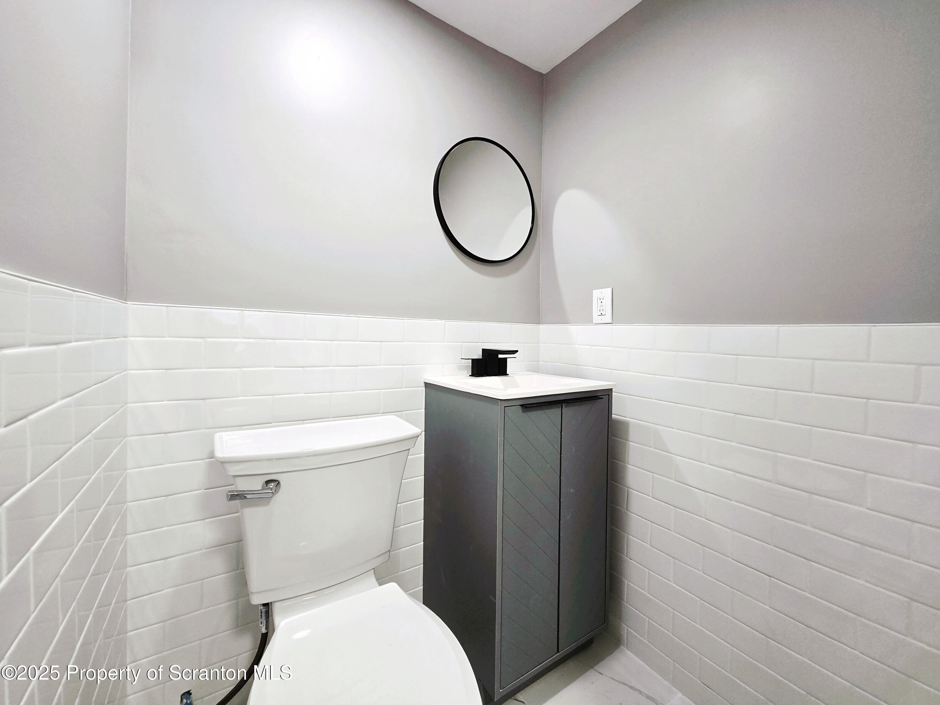 1215 Eynon Street Scranton, PA 18504 - Photo 21 of 23 a bathroom with a toilet sink vanity and mirror