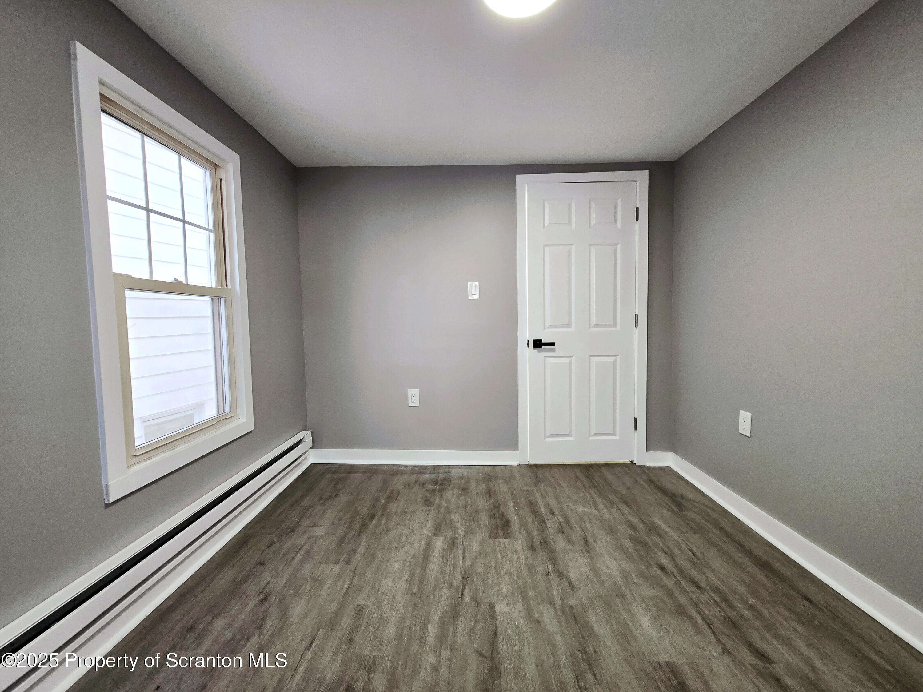 1215 Eynon Street Scranton, PA 18504 - Photo 23 of 32 an empty room with wooden floor and windows
