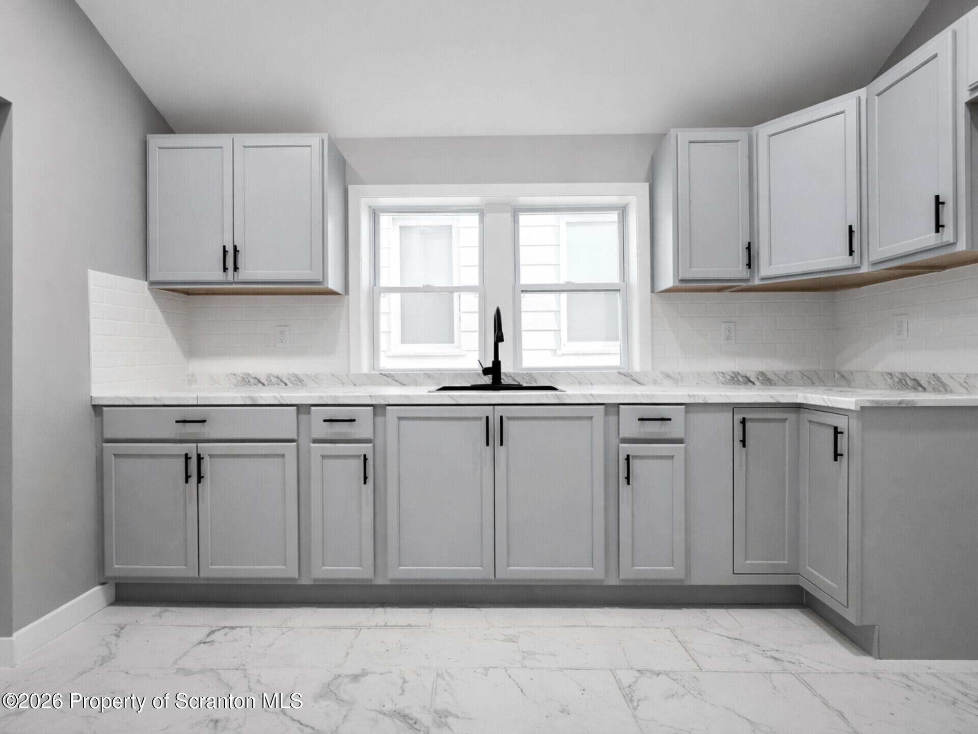 1215 Eynon Street Scranton, PA 18504 - Photo 3 of 23 a kitchen with white cabinets granite counter tops and a window