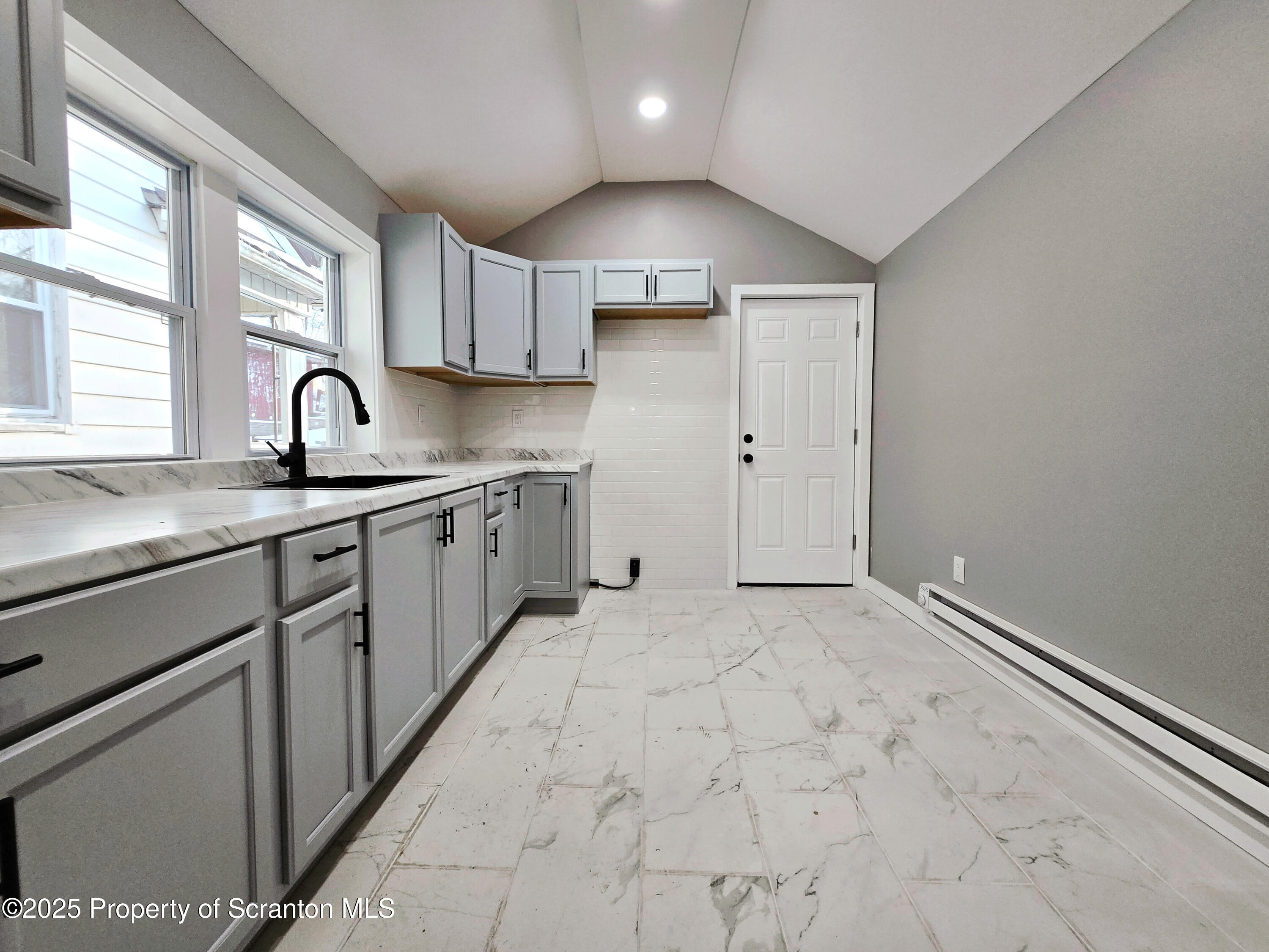 1215 Eynon Street Scranton, PA 18504 - Photo 5 of 32 a kitchen with granite countertop a sink stainless steel appliances and cabinets