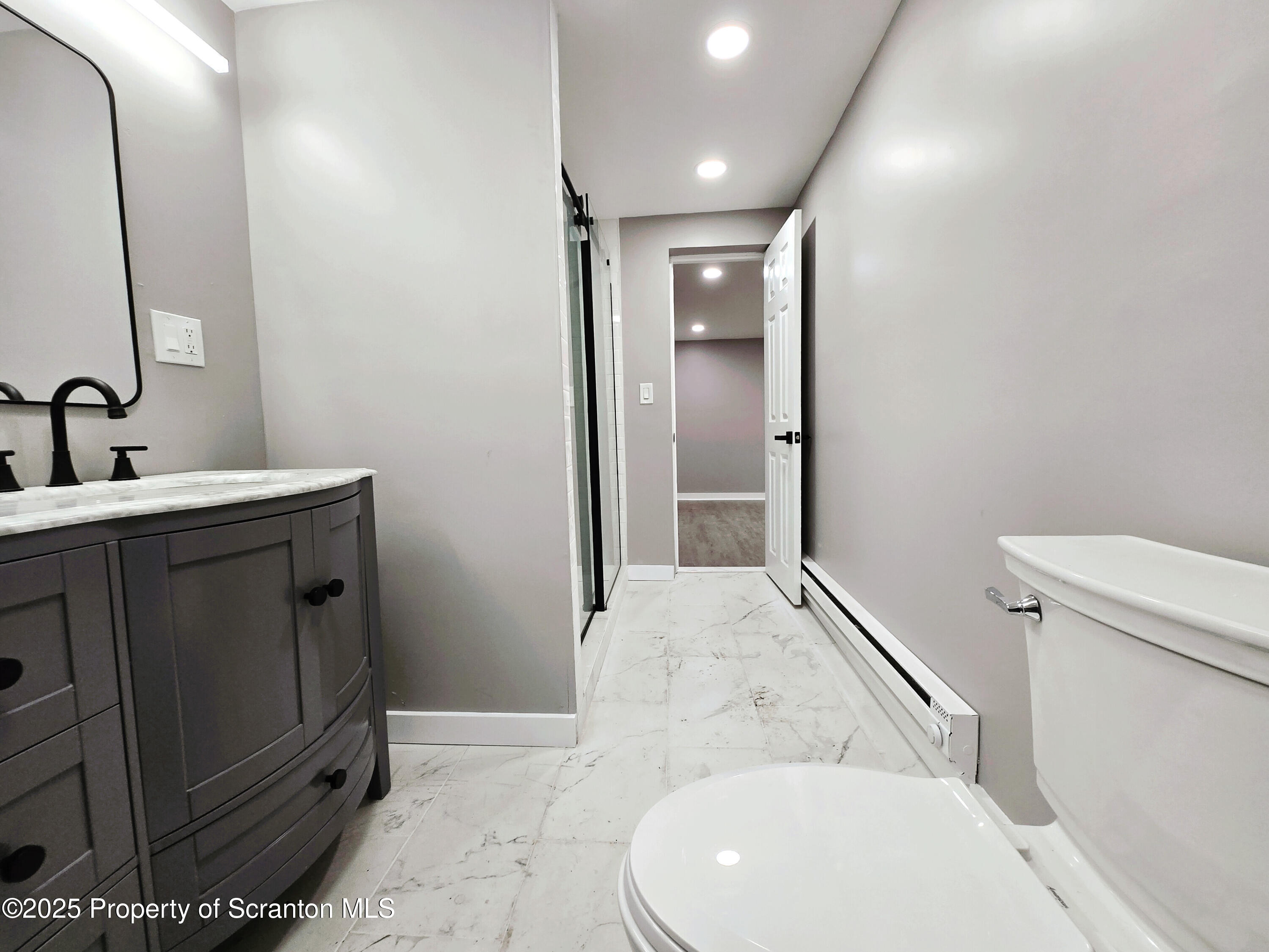 1215 Eynon Street Scranton, PA 18504 - Photo 6 of 23 a bathroom with a toilet sink and mirror