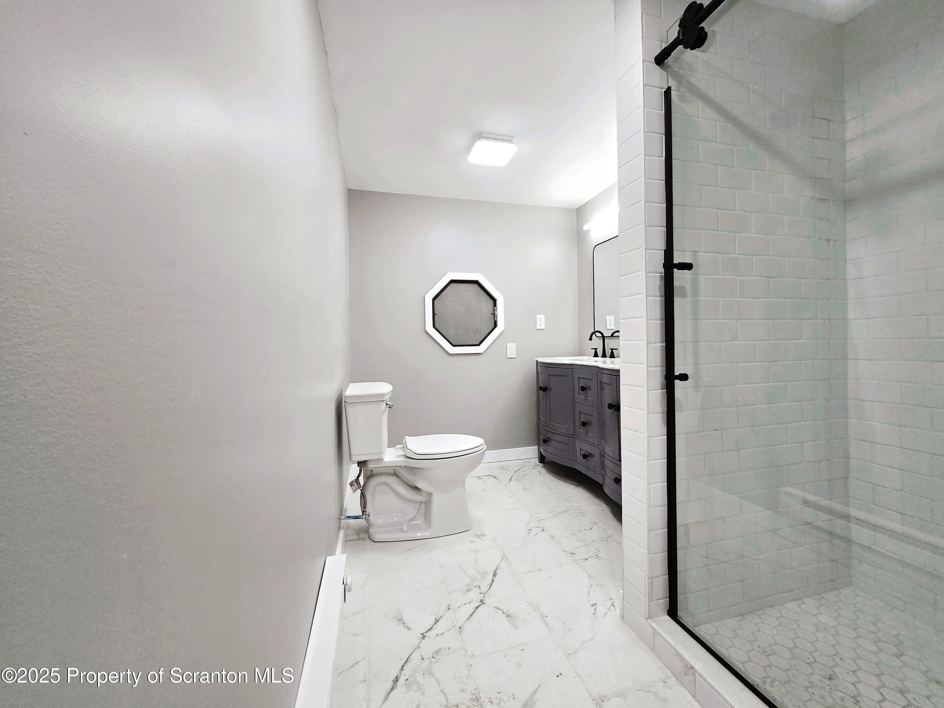 1215 Eynon Street Scranton, PA 18504 - Photo 9 of 32 a bathroom with a toilet a sink and shower