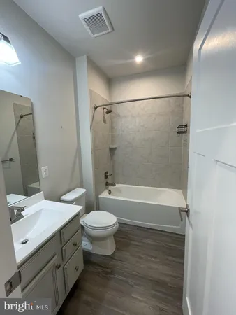 a bathroom with a sink mirror toilet and bathtub