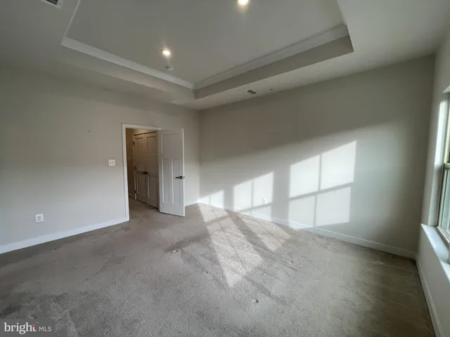 an empty room with windows and closet