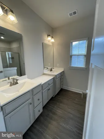 a bathroom with a double vanity sink and mirror