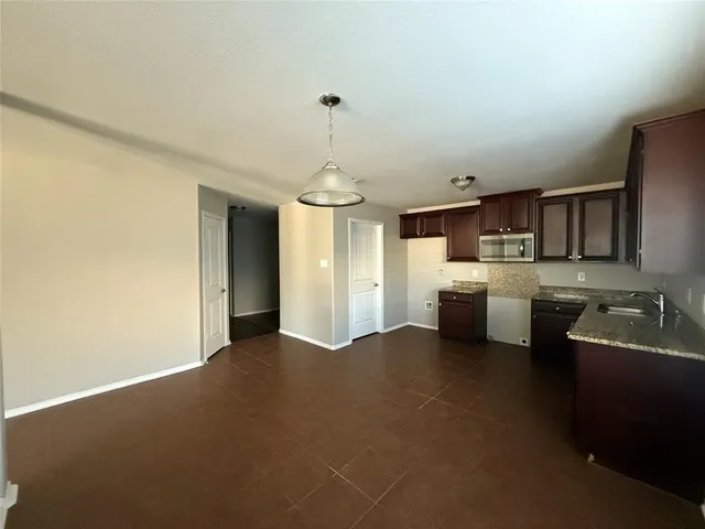 a kitchen with stainless steel appliances a sink stove and refrigerator