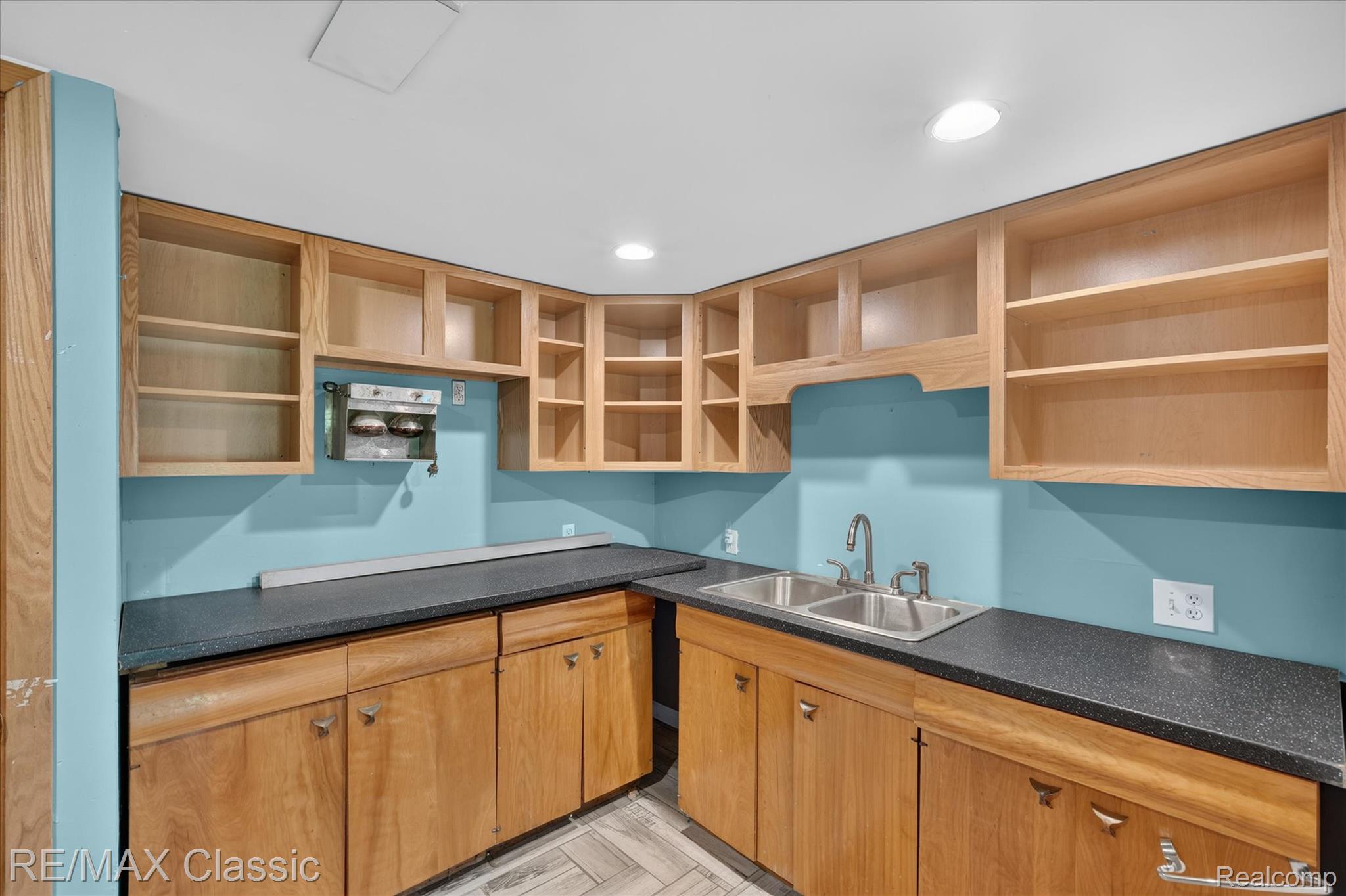 12189 Gage Road Holly, MI 48442 - Photo 39 of 69 Utility area featuring a double basin stainless steel sink, wood-finish cabinetry, dark speckled countertops, and recessed lighting