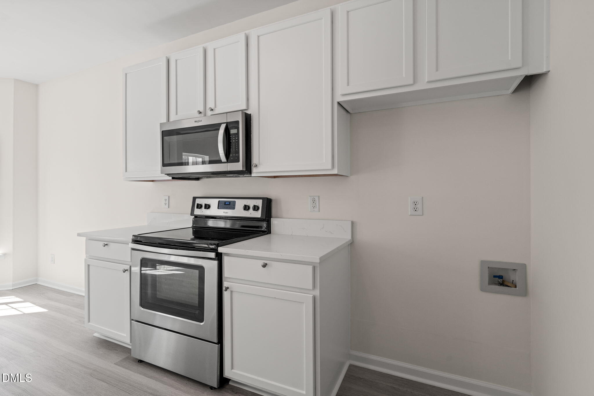 3207 Geary Trail Raleigh, NC 27610 - Photo 14 of 55 a kitchen with white cabinets and stainless steel appliances