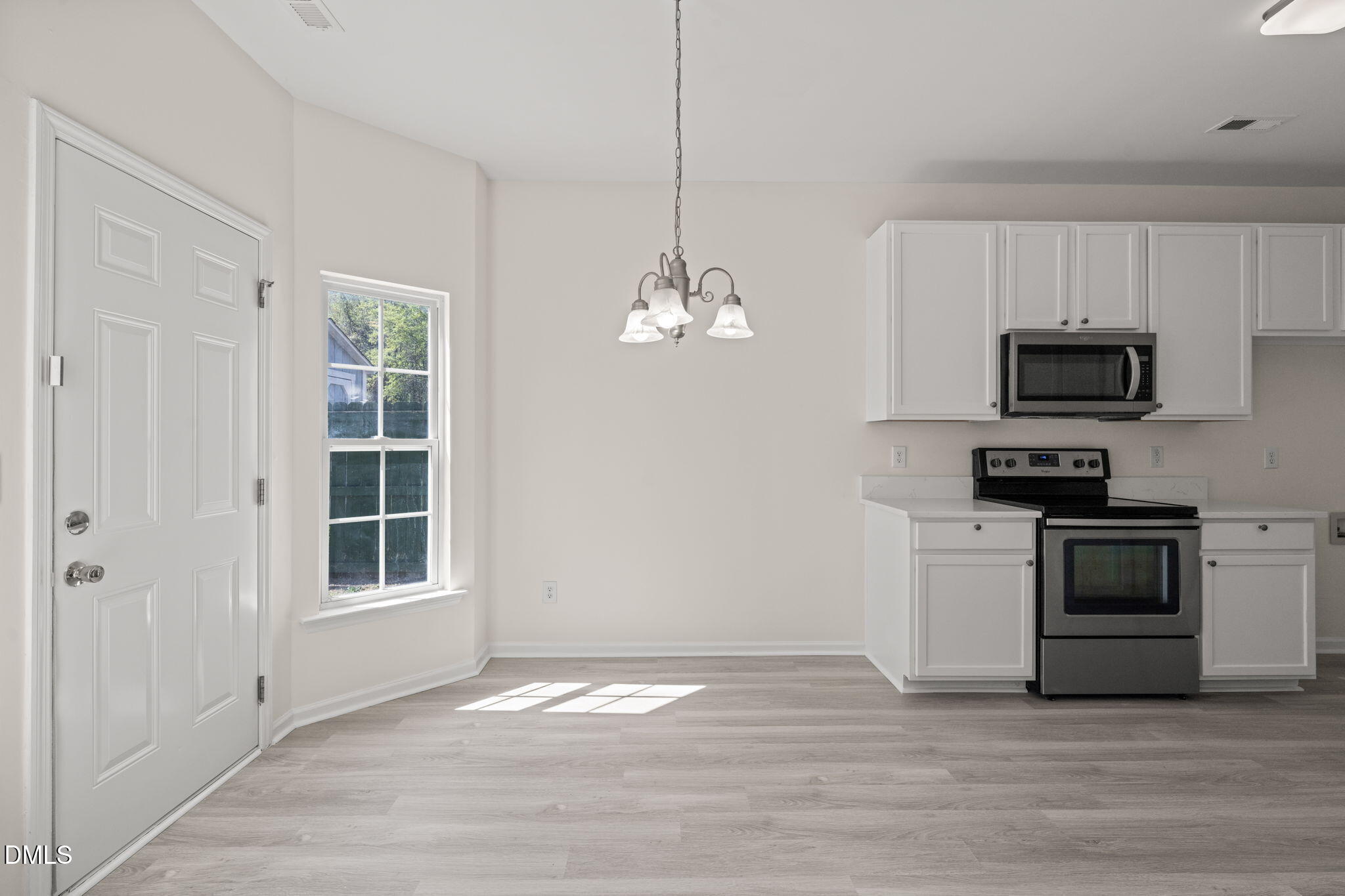 3207 Geary Trail Raleigh, NC 27610 - Photo 16 of 55 a kitchen with kitchen island granite countertop a stove top oven a sink and dishwasher with wooden floor