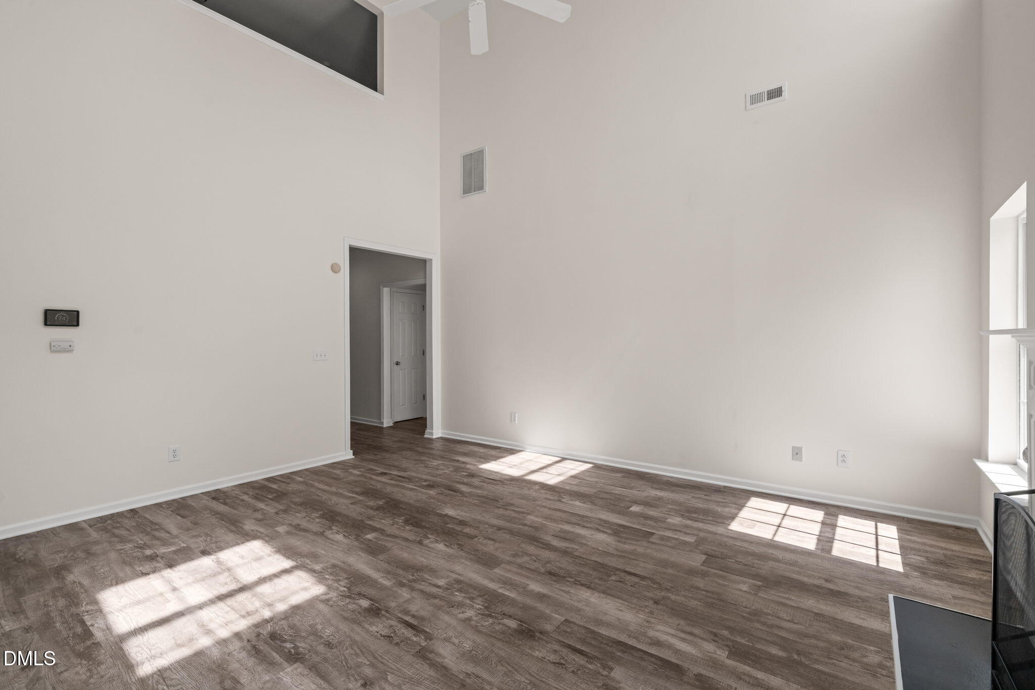 3207 Geary Trail Raleigh, NC 27610 - Photo 17 of 55 a view of an empty room with wooden floor and a window