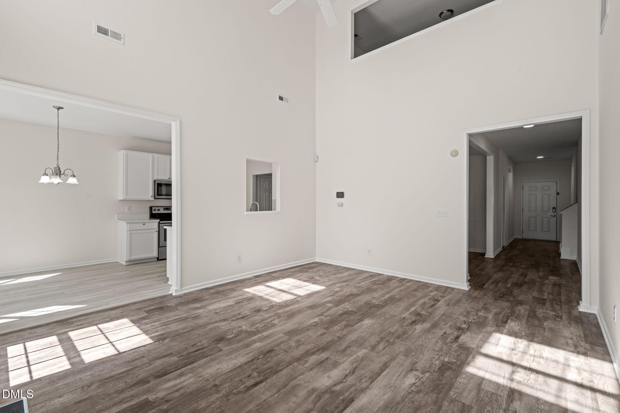 3207 Geary Trail Raleigh, NC 27610 - Photo 18 of 55 a view of a big room with wooden floor and a bathroom