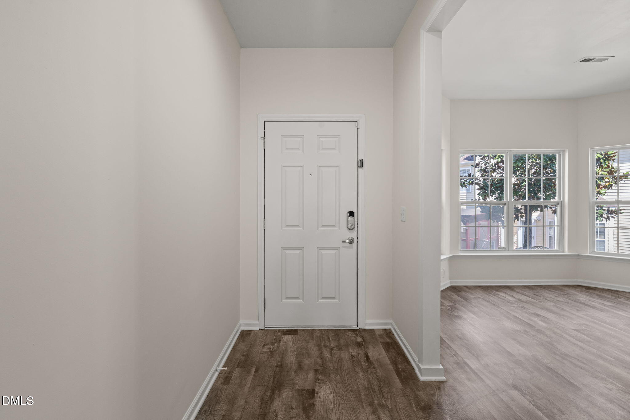 3207 Geary Trail Raleigh, NC 27610 - Photo 4 of 55 an empty room with wooden floor and windows