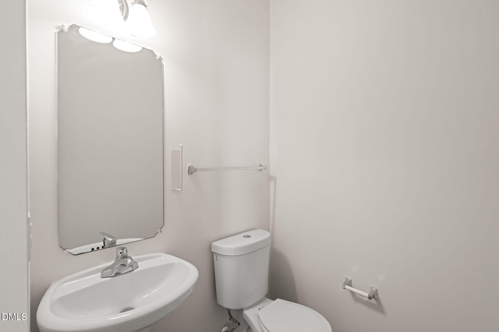 3207 Geary Trail Raleigh, NC 27610 - Photo 6 of 55 a bathroom with a toilet a sink and mirror