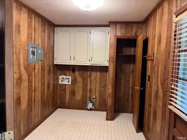 a view of a utility room with granite countertop cabinets