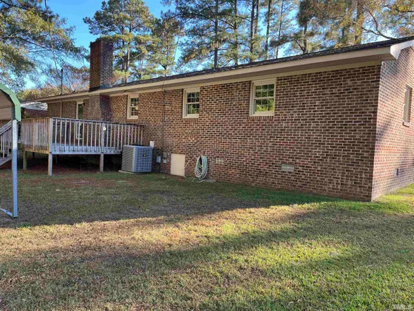 a view of a house with a yard and deck
