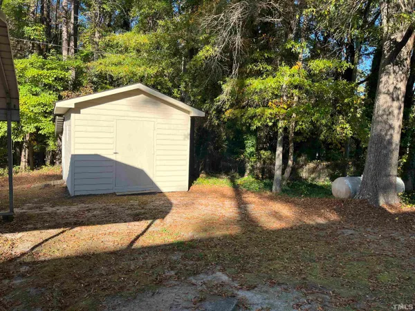 a view of backyard of house with green space