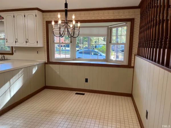 a view of a kitchen with an empty space and a window