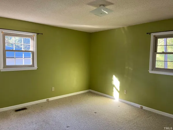 an empty room with a empty space and windows