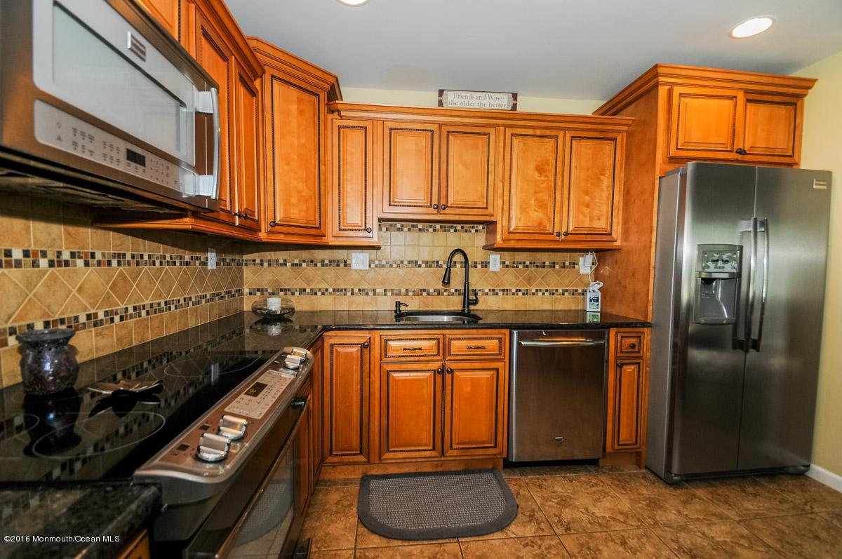 13 Valley Road Manalapan, NJ 07726 - Photo 11 of 26 a kitchen with stainless steel appliances granite countertop a refrigerator a stove and a sink