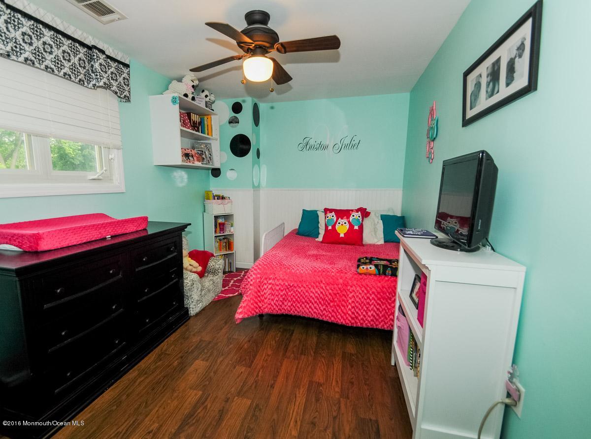 13 Valley Road Manalapan, NJ 07726 - Photo 17 of 26 a bedroom with a bed and a tv in it