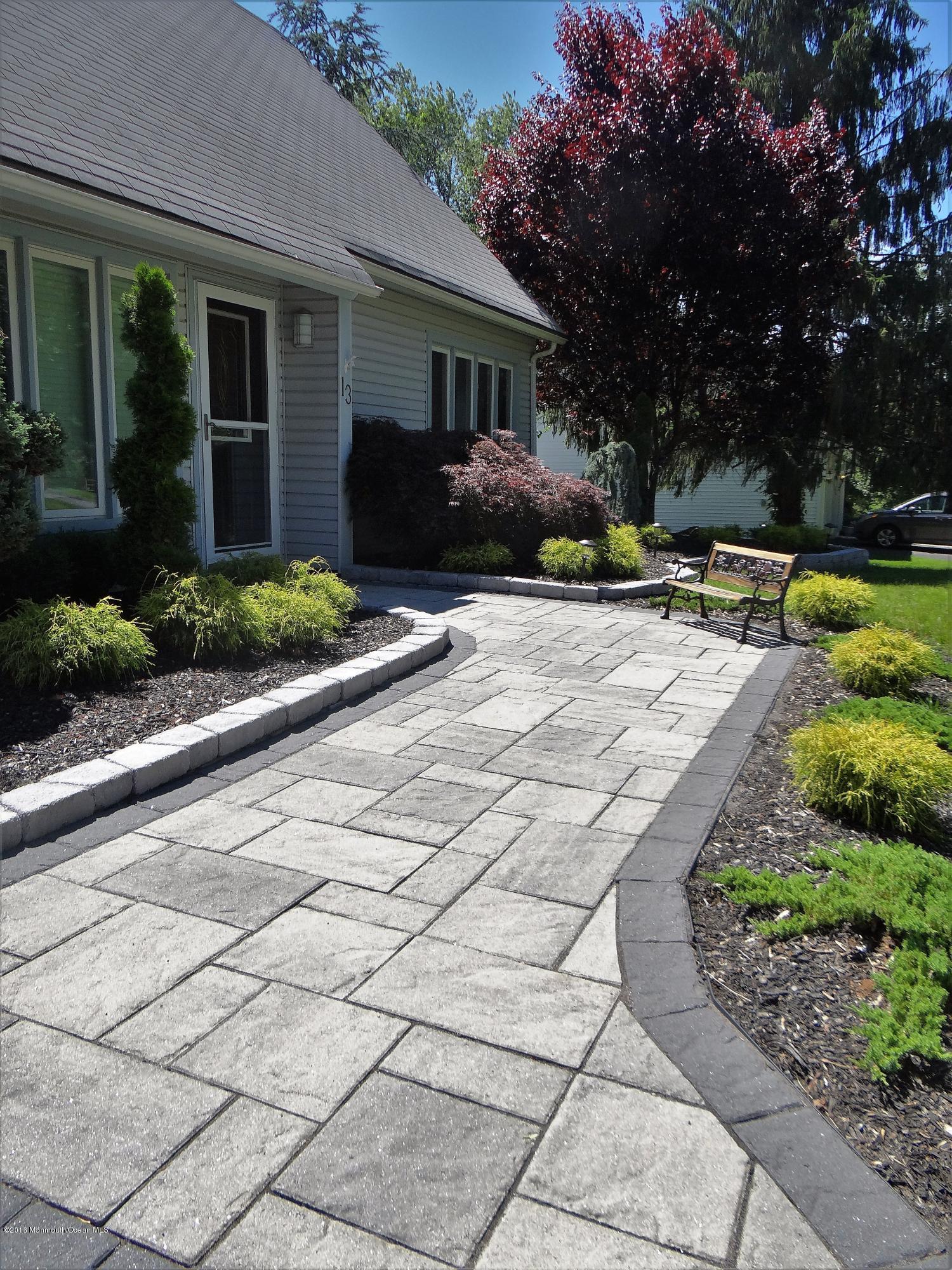13 Valley Road Manalapan, NJ 07726 - Photo 2 of 26 a view of a house with a yard and potted plants