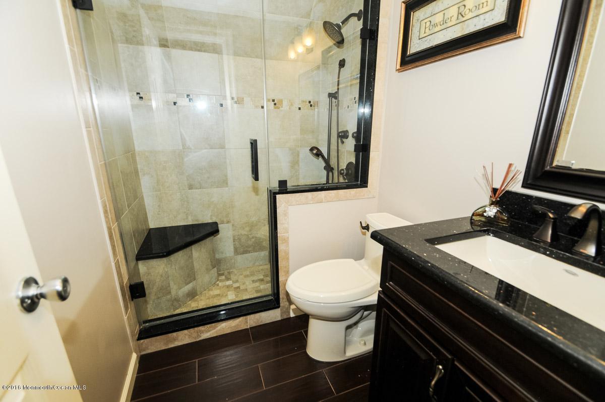 13 Valley Road Manalapan, NJ 07726 - Photo 21 of 26 a bathroom with a sink toilet and shower