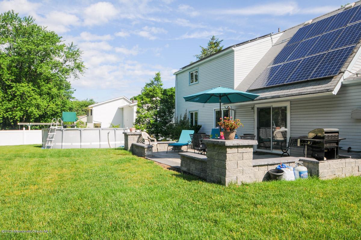 13 Valley Road Manalapan, NJ 07726 - Photo 23 of 26 a view of a house with swimming pool and sitting area