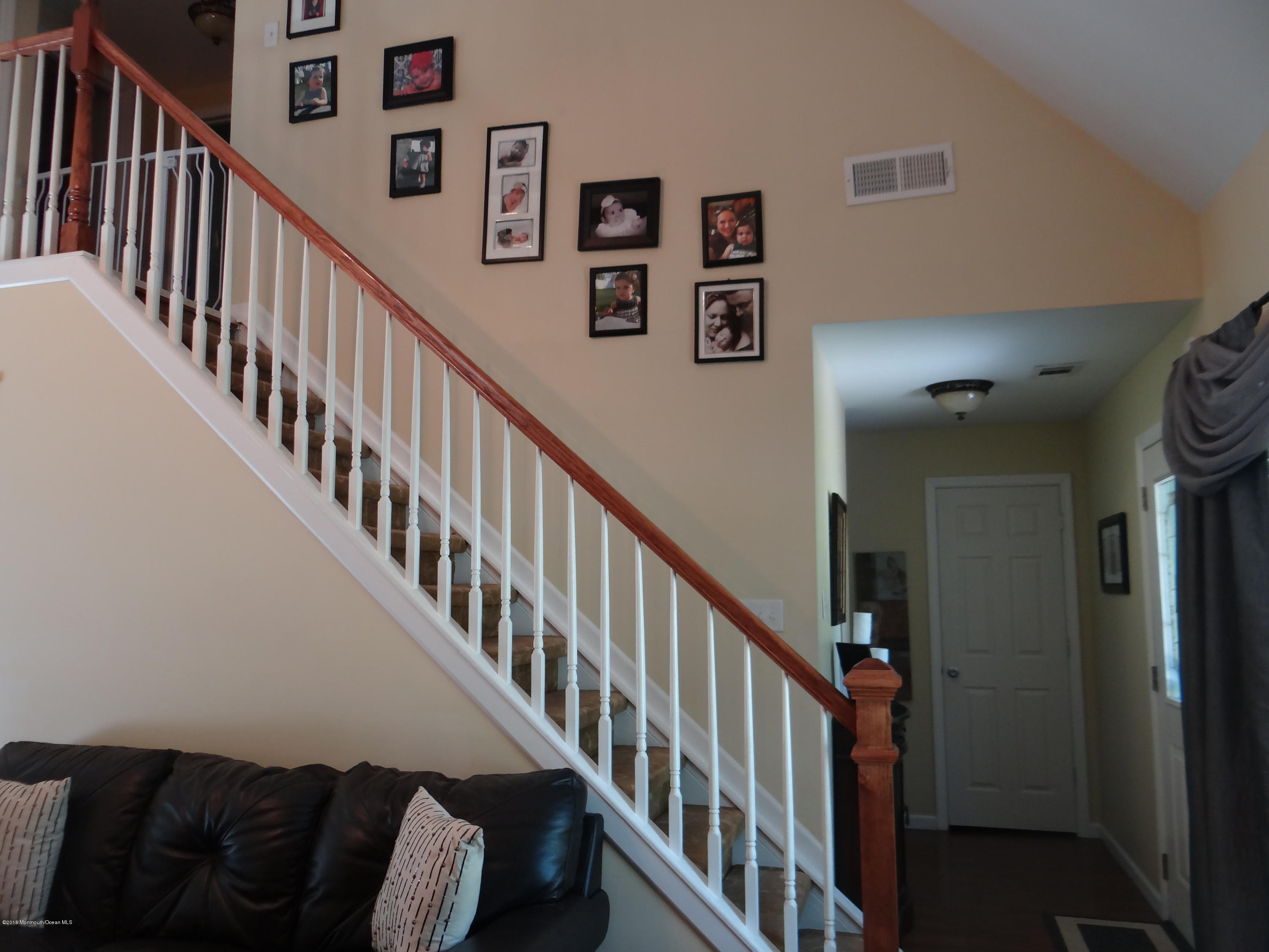 13 Valley Road Manalapan, NJ 07726 - Photo 9 of 26 a view of staircase with lots of frames on wall and a view of a staircase