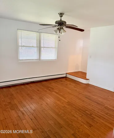 wooden floor in an empty room with a window