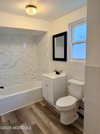 a bathroom with a toilet a sink and bathtub
