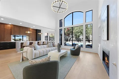 a living room with furniture fireplace and a large window
