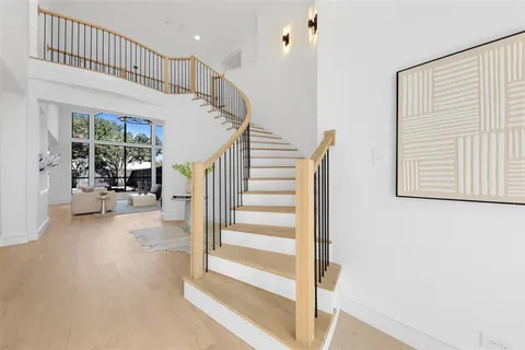 a view of entryway and hall with wooden floor