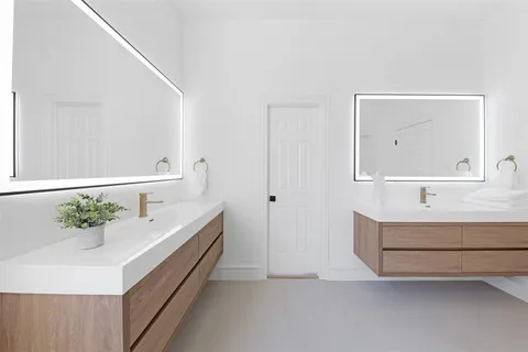 a spacious bathroom with a double vanity sink and a mirror